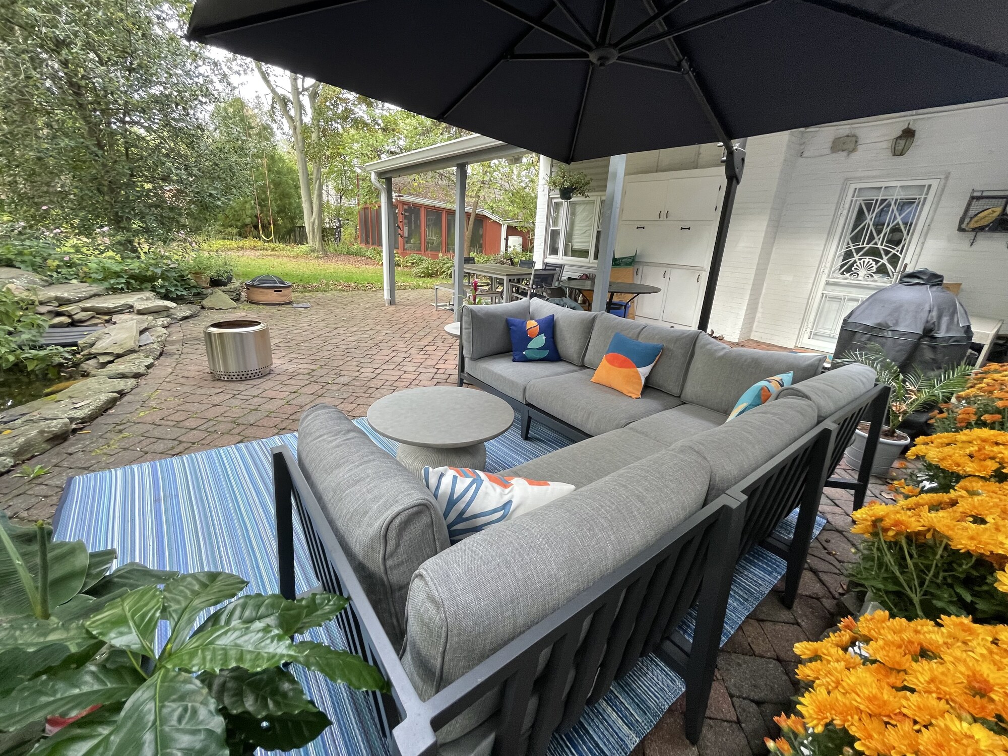 A Mid-Century–Style Patio with Pond Views - Photo 1